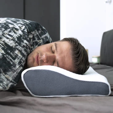 guy sleeping on his side using DreamyFoam pillow